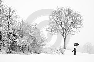 Lonely woman walking in snow storm