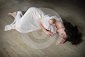 Lonely woman on wooden floor
