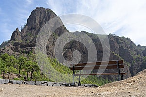 Lonely wooden bench in the mountain in relax and peaceful view point. Place to rest and calm spot with great peak and empty sea