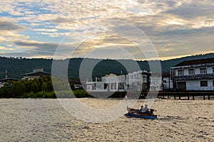 A lonely wooden fishing boat returns to the village after night catching at dawn