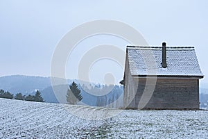 lonely wooden house on a field on a hill