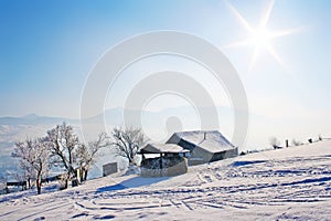 Lonely wooden house in mountains under blue sky