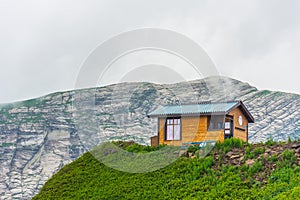 Lonely wooden house on top of a mountain