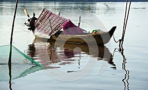 Lonely wooden rowboat on river