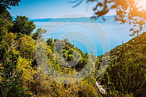 Lonely yacht between hills on hidden Fteri beach lagoon, Kefalonia, Greece