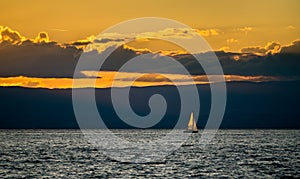 Lonely yacht on Lake Geneva at sunset in Switzerland