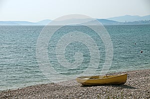 Lonely yellow boat at the seaside