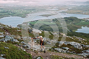 Lonely young man hiking on mountain at sunset