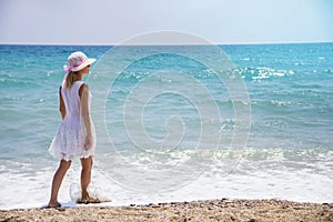 Lonely young woman walking on the beach