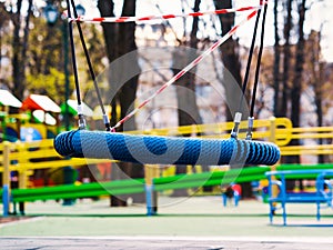 Lonesome swings on abandoned playground during covid pandemic