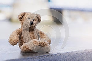 Loney teddy bear sitting by the river, The forgotten bear sitting alone, lost property, Lonely concept, Lost child, International