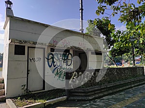 a long-abandoned public bathroom with vandalism paint