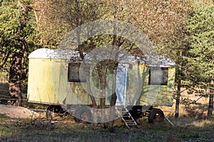 Long ago abandoned trailer green yellow warm sunny day autumn vibrant colors near ranch in bulgaria