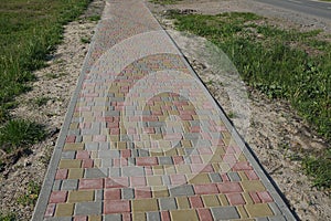 Long alley of colored paving slabs