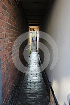 A long alley way in between two buildings