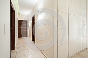 Long anteroom inside bright apartment