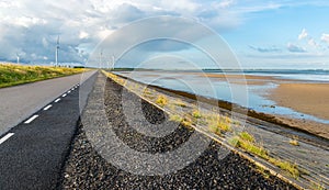 Long asphalt road on a Dutch along an estuary