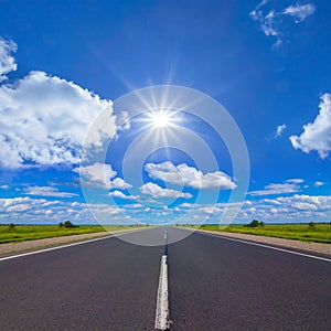 long asphat road under a sparkle sun