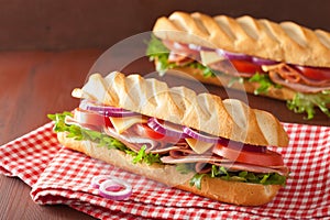 Long baguette sandwich with ham cheese tomato lettuce