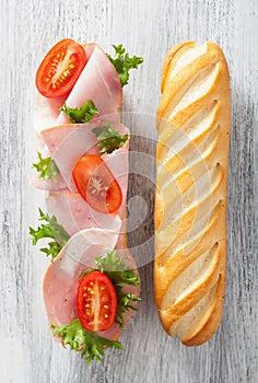 Long baguette sandwich with ham tomato lettuce