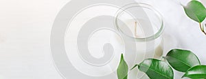 Long Banner for Organic Cosmetics Wellness White Candle in Glass Jar Fresh Tree Branches with Green Leaves on Wood Background. Spa