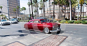 Long Beach, California USA - April 11, 2021: red chevrolet kustom famous retro car left side view