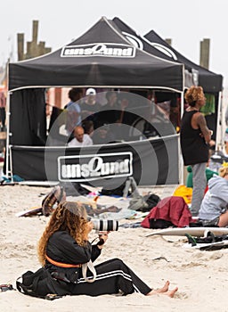 Long Beach, New York - September 13, 2018 : Unsound Pro photographer on the beach near an the event tent.