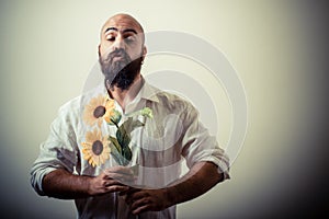 Long beard and mustache man giving flowers