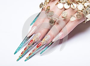 Long beautiful manicure on the fingers of turquoise and red. Nails design. Isolate object. Close-up