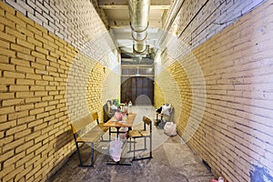 The long beige corridor with brick walls