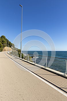 A long bike path overlooking the sea with no one around