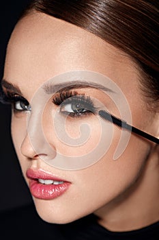 Long Black Eyelashes. Woman With Makeup Applying Cosmetics