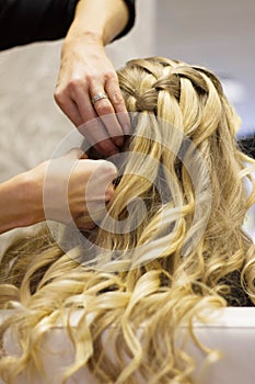 Long blonde hair being platted