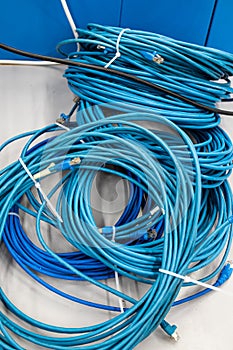 Long blue network cable cord bunch set on a work benc