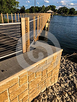 Long boardwalk with railings by lake
