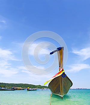 long boat on beautiful sand beach and tropical sea and blue sky at Phi phi island in Krabi,  Thailand