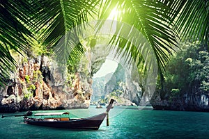 Long boat and rocks on beach in Krabi