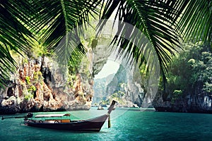 Long boat and rocks on beach in Krabi photo