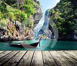 Long boat and rocks on railay beach in Krabi photo