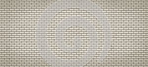 Long brick wall made of beige refractory bricks. Abstract background for design. Backdrop for text. Copy space