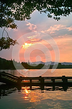 Long bridge by China West Lake at Sunset