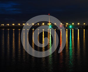 Long bridge in lights at night.