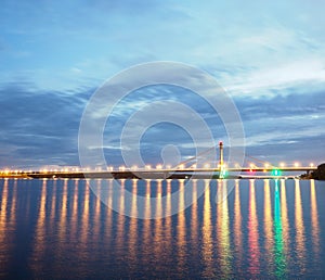 Long bridge in lights at night.