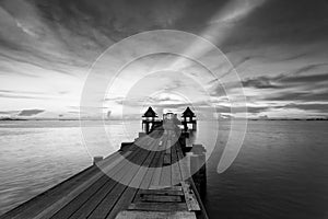 The long bridge over the sea with a beautiful sunrise in black a