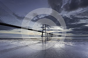 Long bridge over tagus river in Lisbon at sunrise