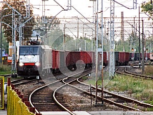 Freight train approaching railroad terminal in Poland.