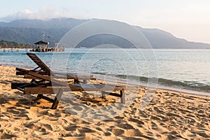 Long chairs on a beach in Pulau Tioman, Malaysia photo