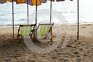 Long chairs on the beach with sunset. Pattaya, Thailand.