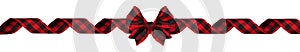 Long Christmas border of red and black buffalo plaid bow and ribbon isolated on white