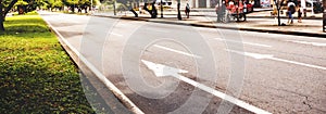 long city street with signage in sunny day photo